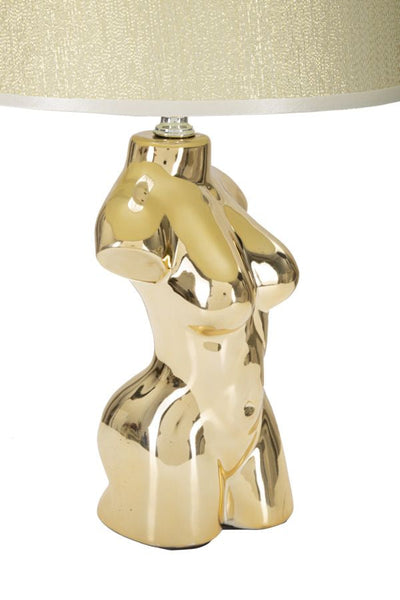 Lampe de table torse féminin en céramique dorée