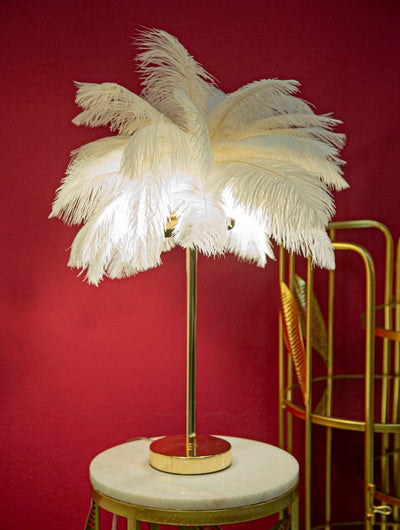 Lampe à poser en métal doré et plumes blanches