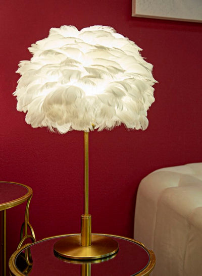 Lampe à poser en métal doré et plumes blanches